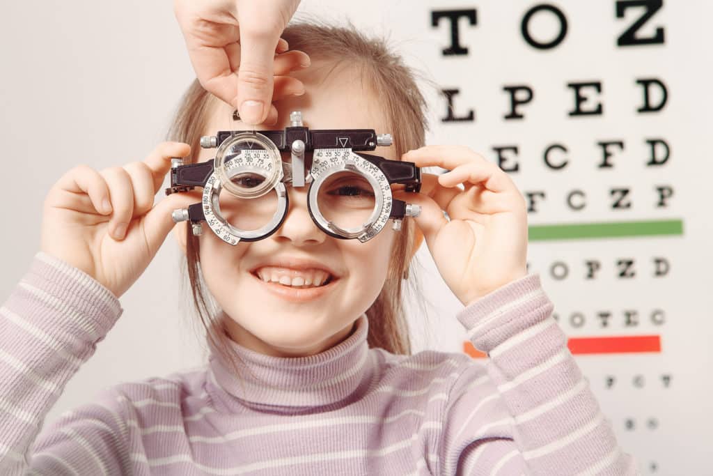 A small girl examining her vision