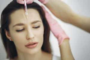 A woman undergoing Botox Cosmetic Procedure